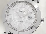 a close up of a watch on a white surface