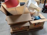 a pile of cardboard boxes with a red hat on top of it