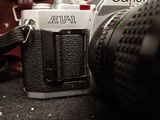 an image of a camera with a leather case in the background