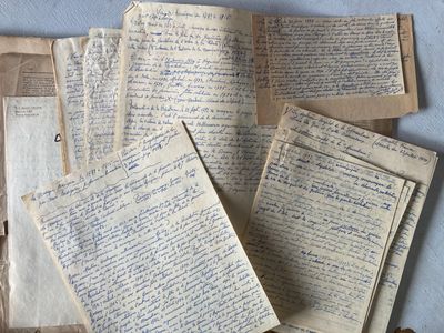 a pile of old papers on a blue surface