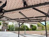 a pergolated roof on a covered patio area