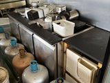a kitchen with a lot of gas cans and a stove