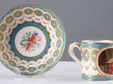 a cup and saucer with a picture of a woman on it