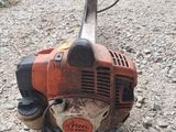 an image of a chainsaw sitting on the ground