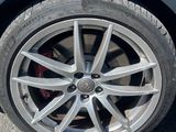 a close up of a car ' s tire on the road