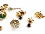 many different types of earrings on a white surface