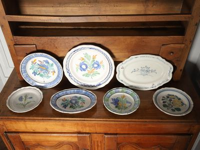 a wooden cabinet with a bunch of plates on top of it