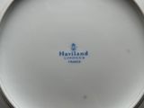 a white plate with a blue and white logo on it