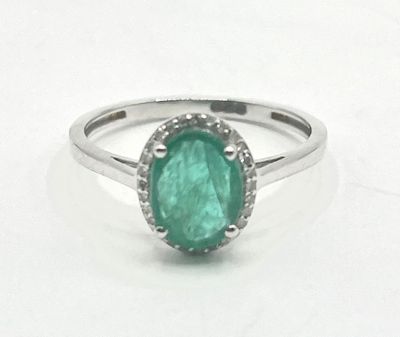 an image of a ring with a green stone in it