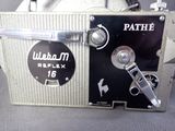 a close up of an old fashioned camera on a table