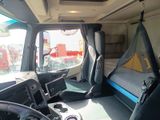 a view of the inside of a truck from the driver ' s seat