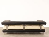 a black and white bench with two pillows on top of it