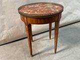 a small table that has a marble top on it