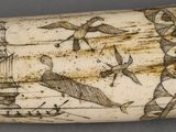 a whale tooth with a ship and birds on it