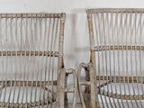 two wicker chairs sitting next to each other on the floor