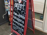 une pancarte sur laquelle on peut lire « outliert » sur le trottoir devant un magasin