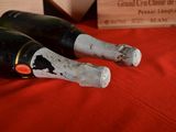 two bottles of wine sitting on a red table