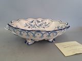 a blue and white bowl sitting on top of a table