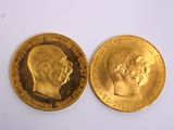 two pieces of gold coins with a man ' s head and a woman ' s head