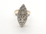 a close up of a diamond ring on a white surface