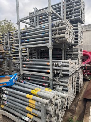 a large pile of steel pipes in a warehouse