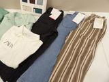 three pairs of pants and a shirt sitting on a table