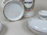 three cups and a saucer sitting on a table