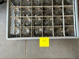 a lot of empty wine glasses in a metal box