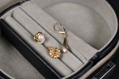 a pair of earrings sitting in a case on a table