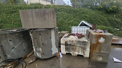 a pile of trash sitting on the side of the road