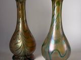 two vases sitting side by side on a white surface