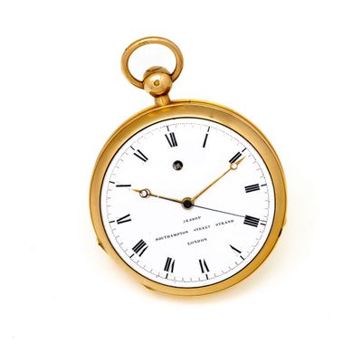 a gold pocket watch with roman numerals on the face