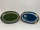 pair of blue and green oval shaped dishes with gold rims