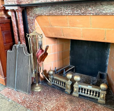 a fire place with a bunch of items on the mantle
