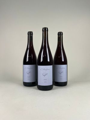 three bottles of wine sitting next to each other on a table