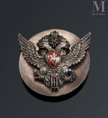 a silver plate with a red and white emblem on it