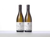 two bottles of white wine sitting on top of a table