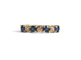 a close up of a gold ring with blue sapphires and diamonds