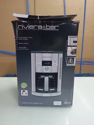 packaging of a coffee maker sitting on a table in front of a cardboard box