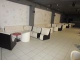 tables and chairs are lined up in a room with white walls