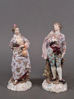 three porcelain figurines of a man and a woman with a child