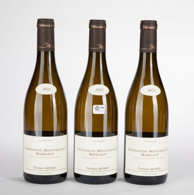three bottles of white wine sitting next to each other on a table