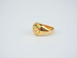 a close up of a gold ring on a white surface