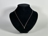 necklace on a mannequin display with a white background