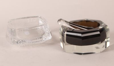 a glass ashtray and a glass ashtray on a table