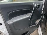 a cat sitting in the driver ' s seat of a car