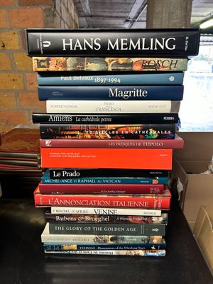 many books stacked on top of each other on a table