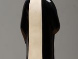 a black and white figurine on a wooden table