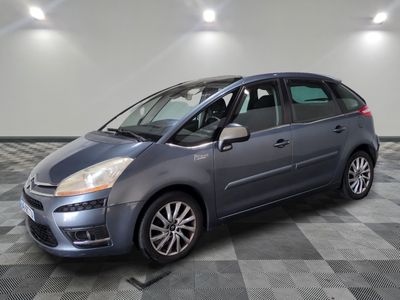 the grey citrole is parked on a checkered tile floor