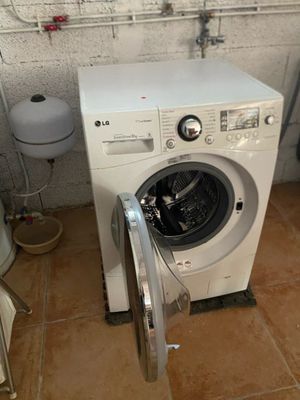 a washer and a toilet in a small room